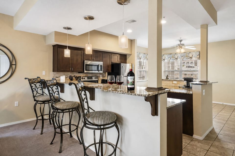 Fully equipped kitchen with upgraded appliances and additional seating at the counter