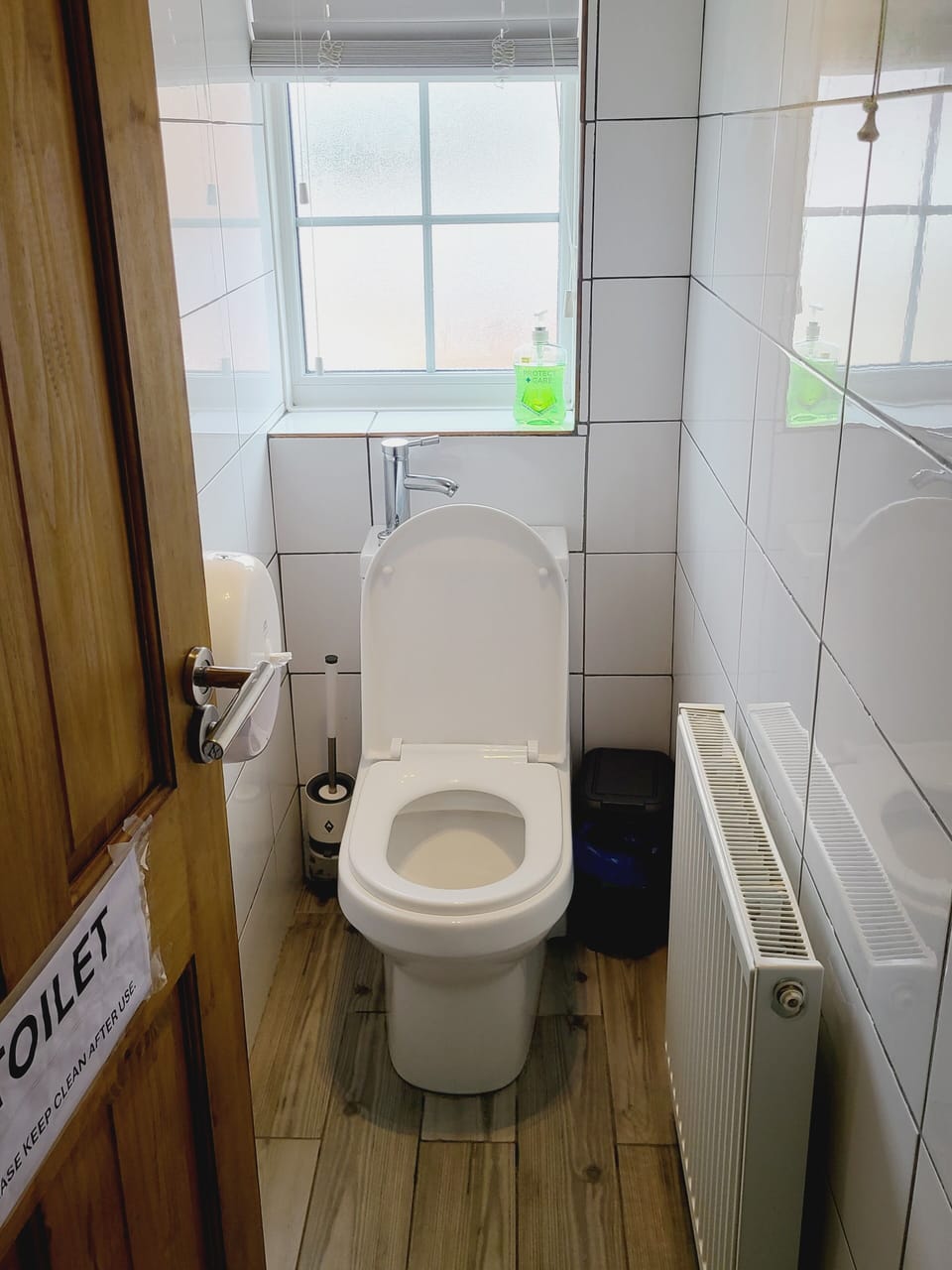 Toilet only room. Sink behind Toilet.