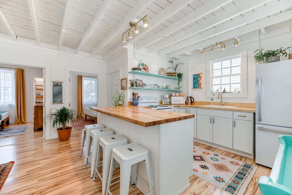 Kitchen - The glazed butcher block breakfast bar, upgraded appliances, and open shelves make High Vibe great place to catch a bite.