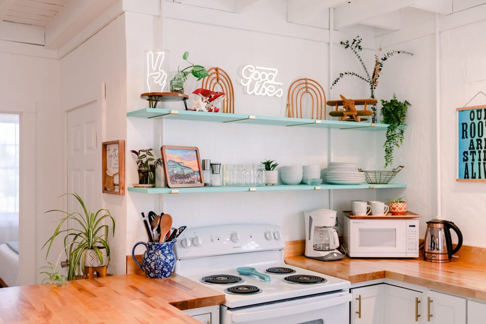 Kitchen - The glazed butcher block breakfast bar, upgraded appliances, and open shelves make High Vibe great place to catch a bite.