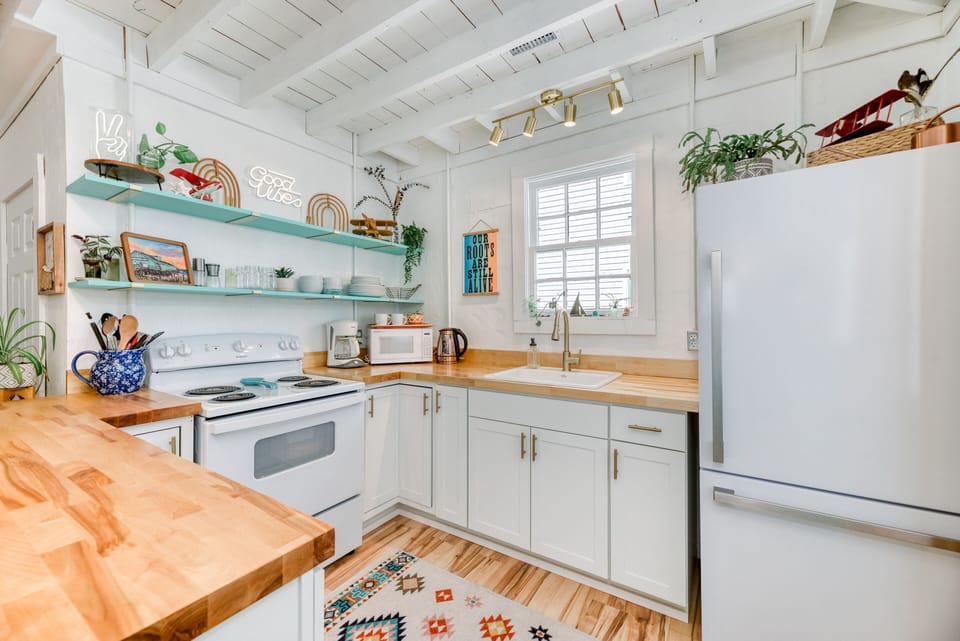 Kitchen - The glazed butcher block breakfast bar, upgraded appliances, and open shelves make High Vibe great place to catch a bite.