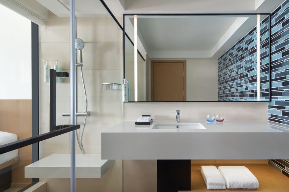 Shower, hair dryer, slippers, towels