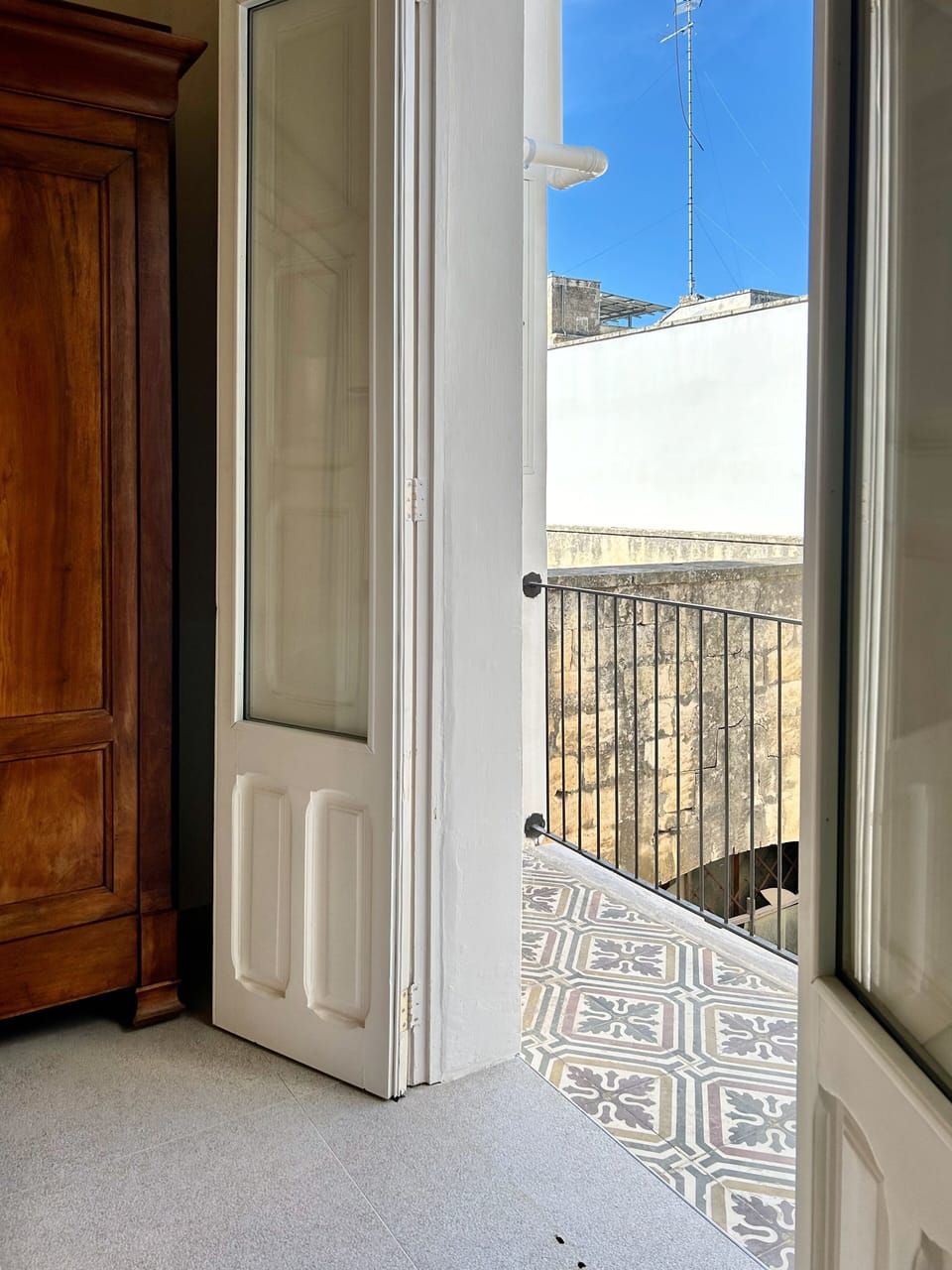Bedroom 2 has its own private balcony featuring restored local tiles typical to the Salento region