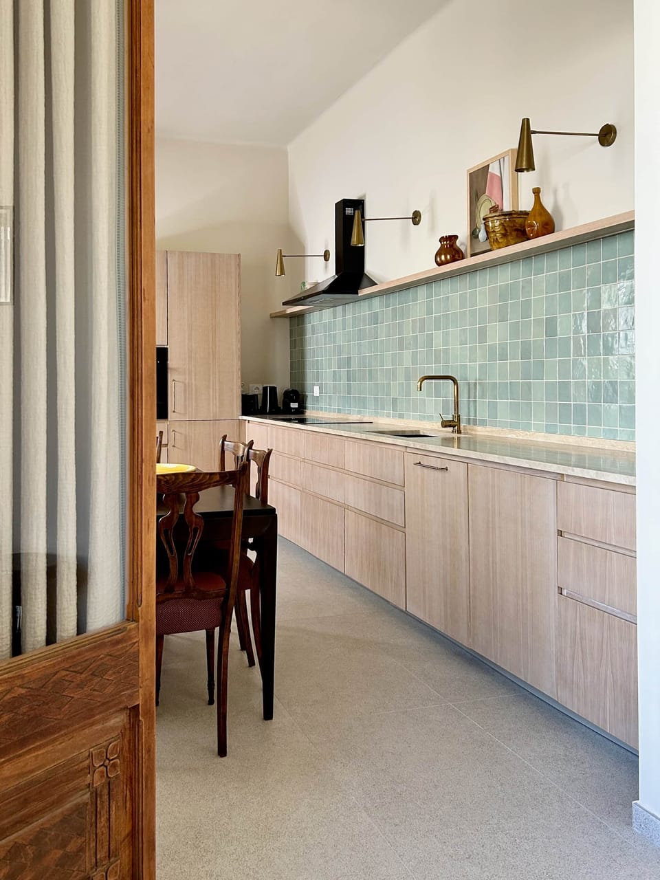 Luxe oak kitchen cabinets with accents of natural brass hand made tiles and marble countertops