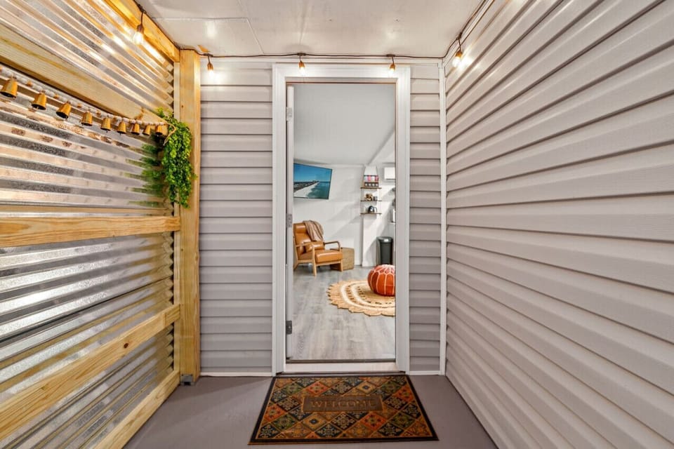 Step into comfort and style through the entryway that leads into our inviting living room, designed to welcome you into a space where relaxation and warmth greet you at the door.