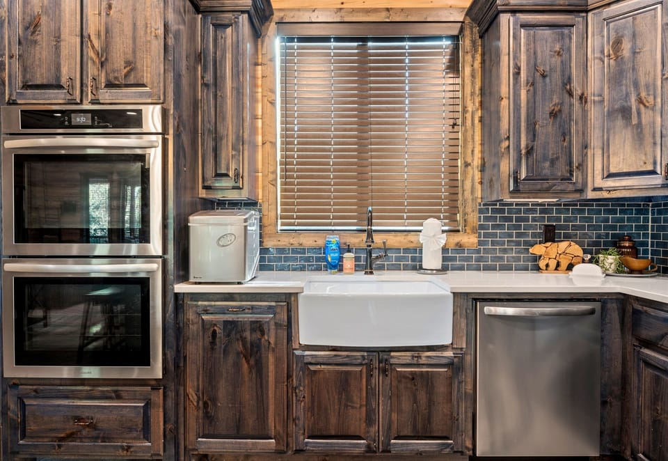 The kitchen combines rustic charm with modern conveniences, perfect for preparing meals after a day of outdoor fun.