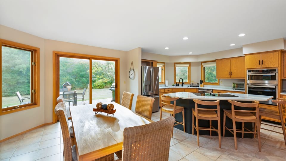 Bright and airy open-concept dining and kitchen area, perfect for gathering and preparing meals together in a welcoming, spacious setting.