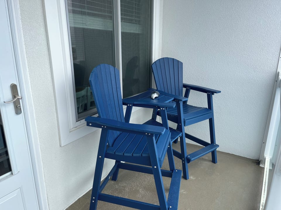 Private balcony with four high Adirondack  chairs.