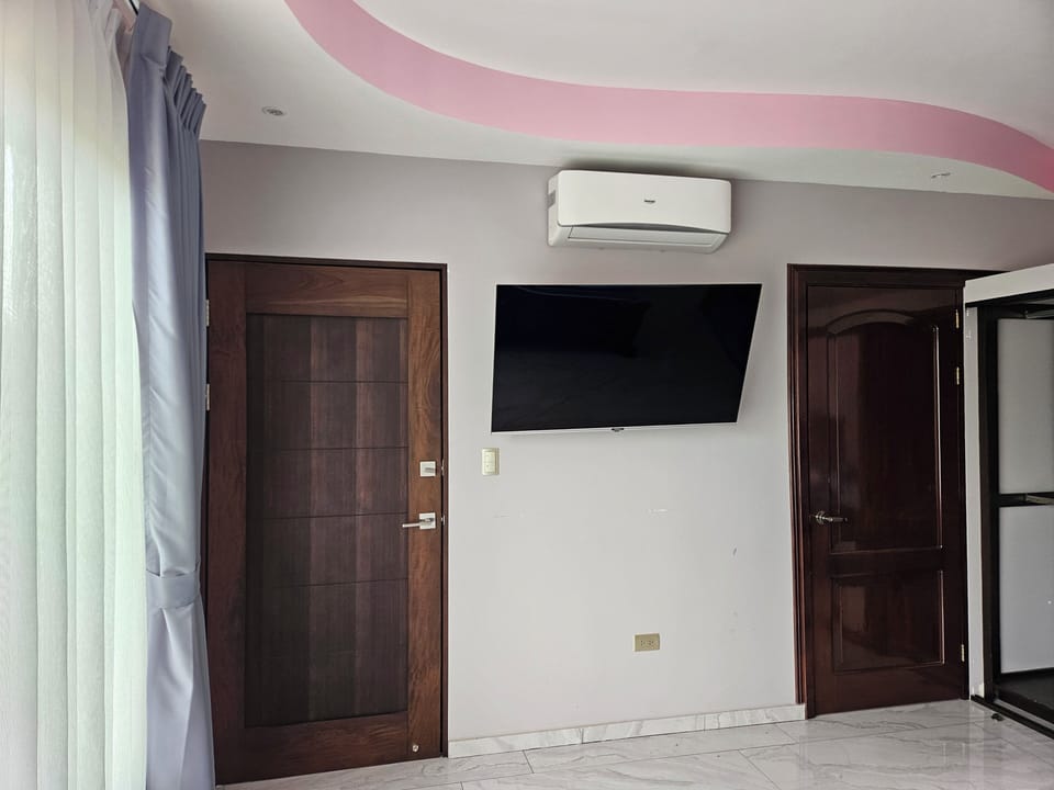 tv and a/c with door to upper balcony