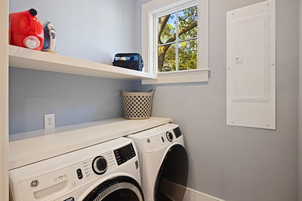 Laundry room area, behind kitchen on first floor