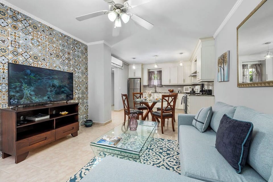 Step into comfort! The vibrant patterned accent wall and plush seating invite you to kick back and make yourself at home. Whether you're planning a quiet night in or a lively chat, this living room sets the perfect scene for your stay.