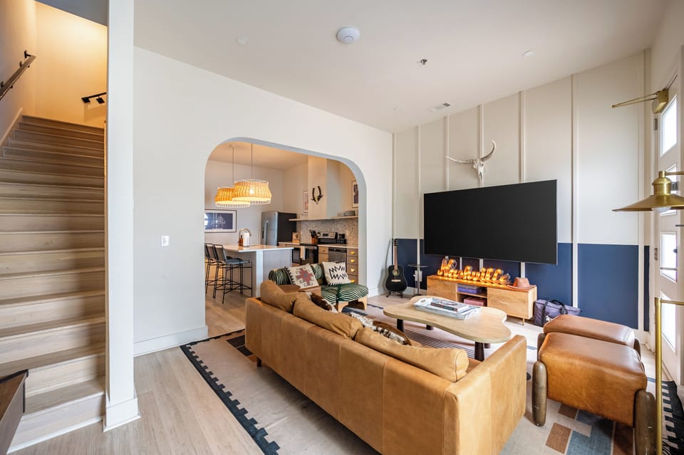 Living room features seating and a TV.