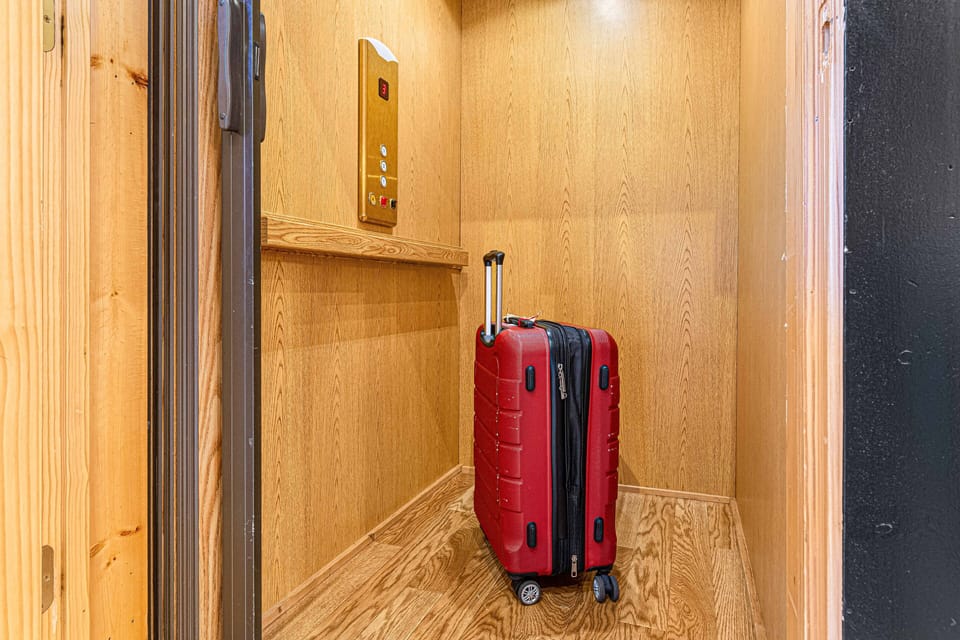 Welcome to your travel haven! 🚪✨ This sleek modern elevator is the perfect blend of convenience and style, with a bright red suitcase ready for your adventures. Experience the ease and comfort of your getaway every step of the way!property.