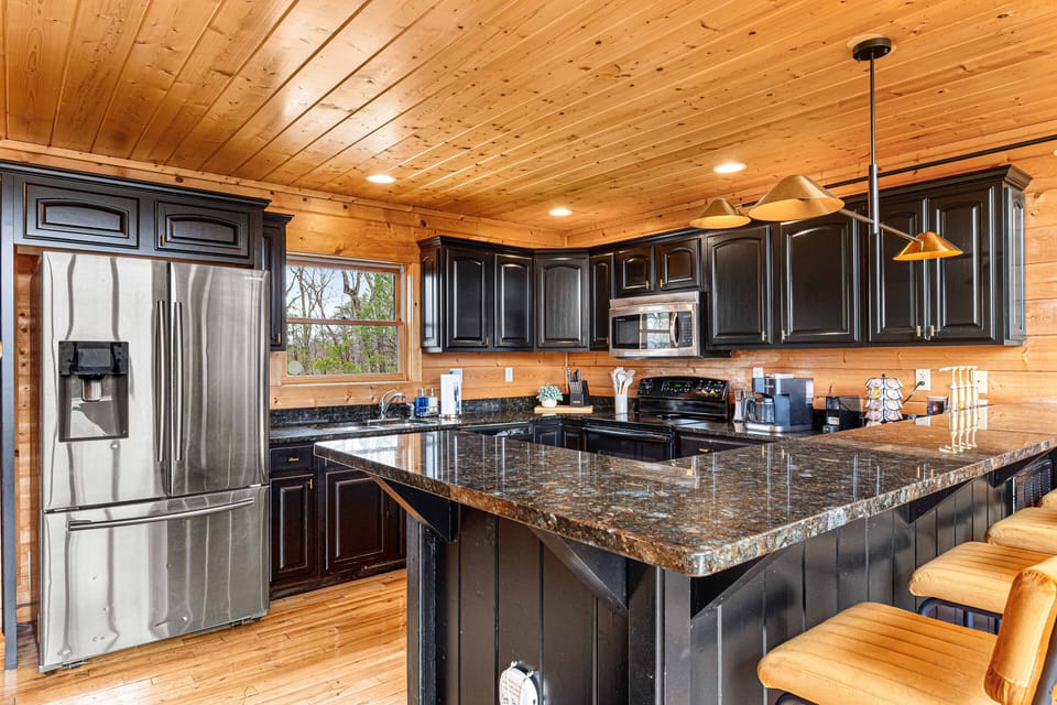 Welcome to the heart of the cabin! 🍳✨ This gourmet kitchen beautifully merges modern convenience with traditional charm, featuring state-of-the-art appliances and rustic finishes. Whether you’re whipping up a family meal or enjoying a quiet cup of coffee, this culinary haven is designed for both functionality and warmth.