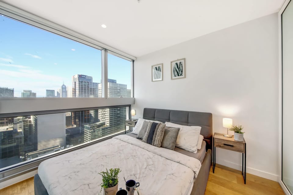 The master bedroom with a queen-sized bed and plush pillows.