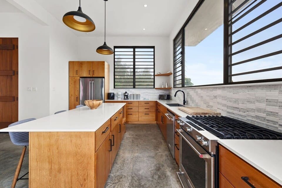 The well-equipped kitchen is a chef's delight, stocked with all the essential kitchen gadgets, gas stove, dishwasher and featuring a gas grill on the patio with an additional sink.