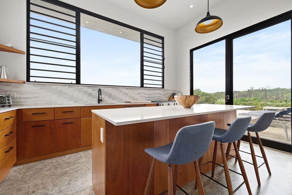 The well-equipped kitchen is a chef's delight, stocked with all the essential kitchen gadgets, gas stove, dishwasher and featuring a gas grill on the patio with an additional sink.