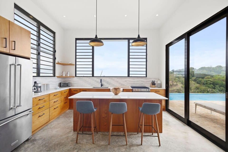 The well-equipped kitchen is a chef's delight, stocked with all the essential kitchen gadgets, gas stove, dishwasher and featuring a gas grill on the patio with an additional sink.