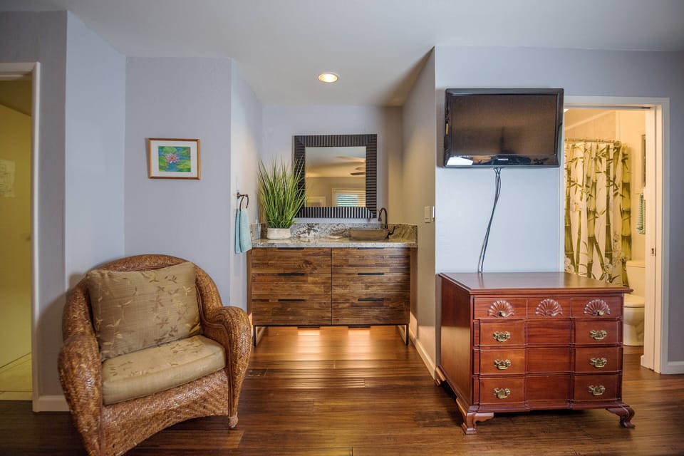 Relax in this cozy sitting area featuring a chic vanity with granite countertops, perfect for unwinding after exploring nearby beaches and attractions.