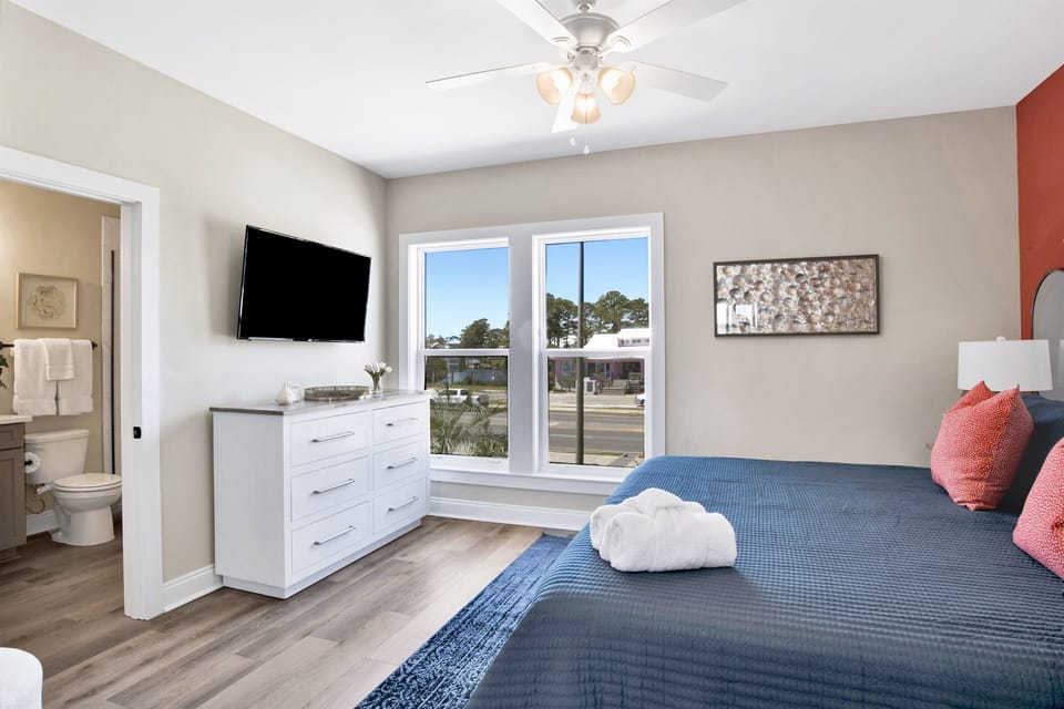 A blend of vibrant accents and tranquil blues offers an oasis of calm with a view, beckoning sweet dreams and sun-kissed awakenings.