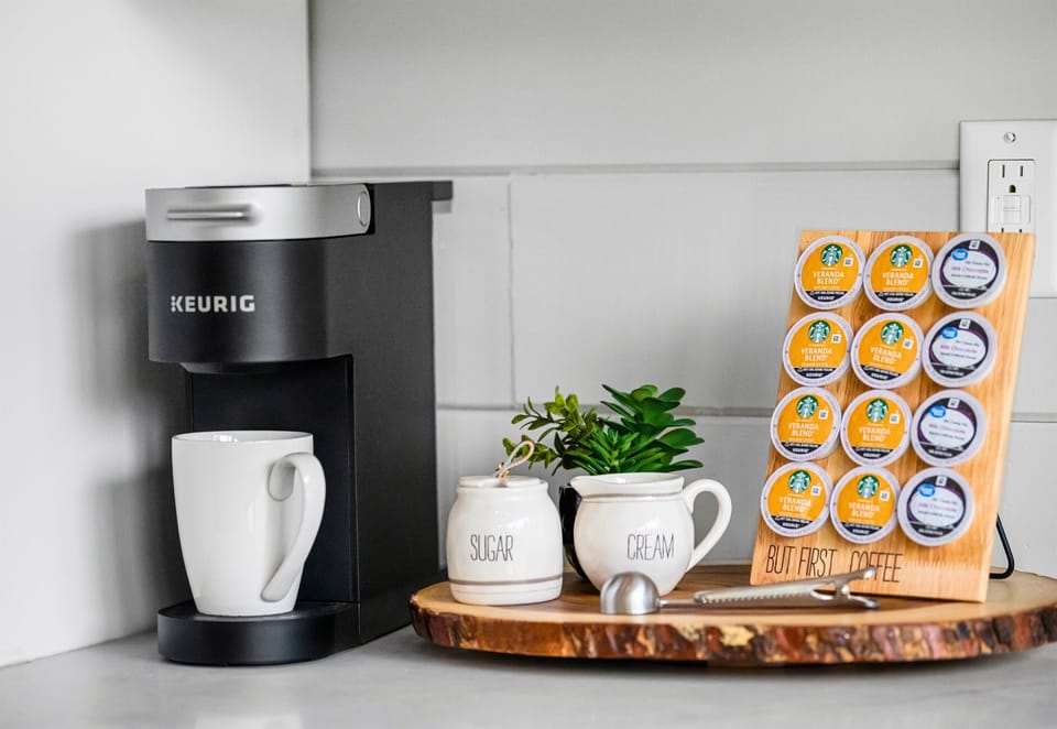 Wake up to the smell of freshly brewed coffee from the well-organized station, equipped with a modern Keurig and a variety of blends.