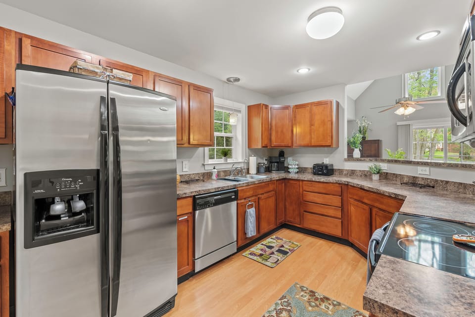 A well-equipped kitchen with a refrigerator, dishwasher, and sink.