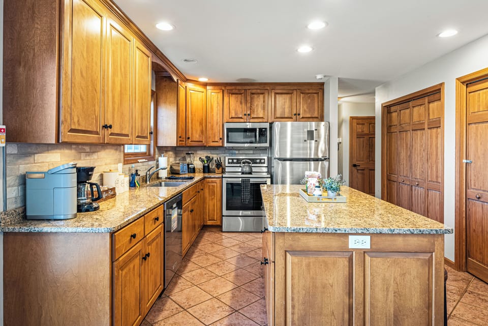 Kitchen features modern stainless steel appliances.