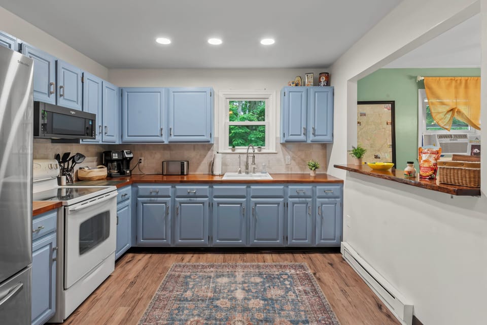 Sleek and Functional: Our kitchen boasts matching cupboards and all the essentials.
