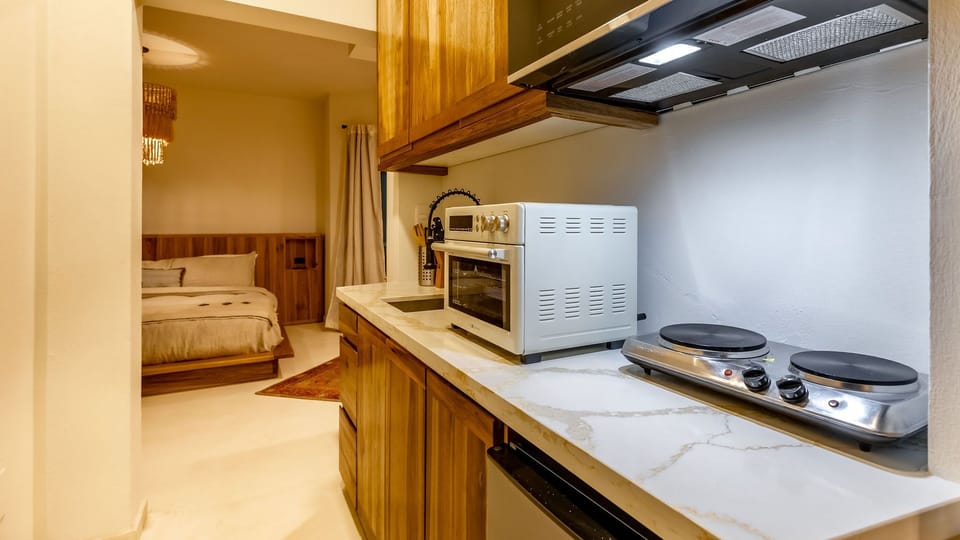 Functional kitchenette entrance with easy access to all amenities. Includes AC, Smart TV, fast Starlink Wi-Fi, hot water, and immediate access to the beach from a true oceanfront building on Kite Beach.