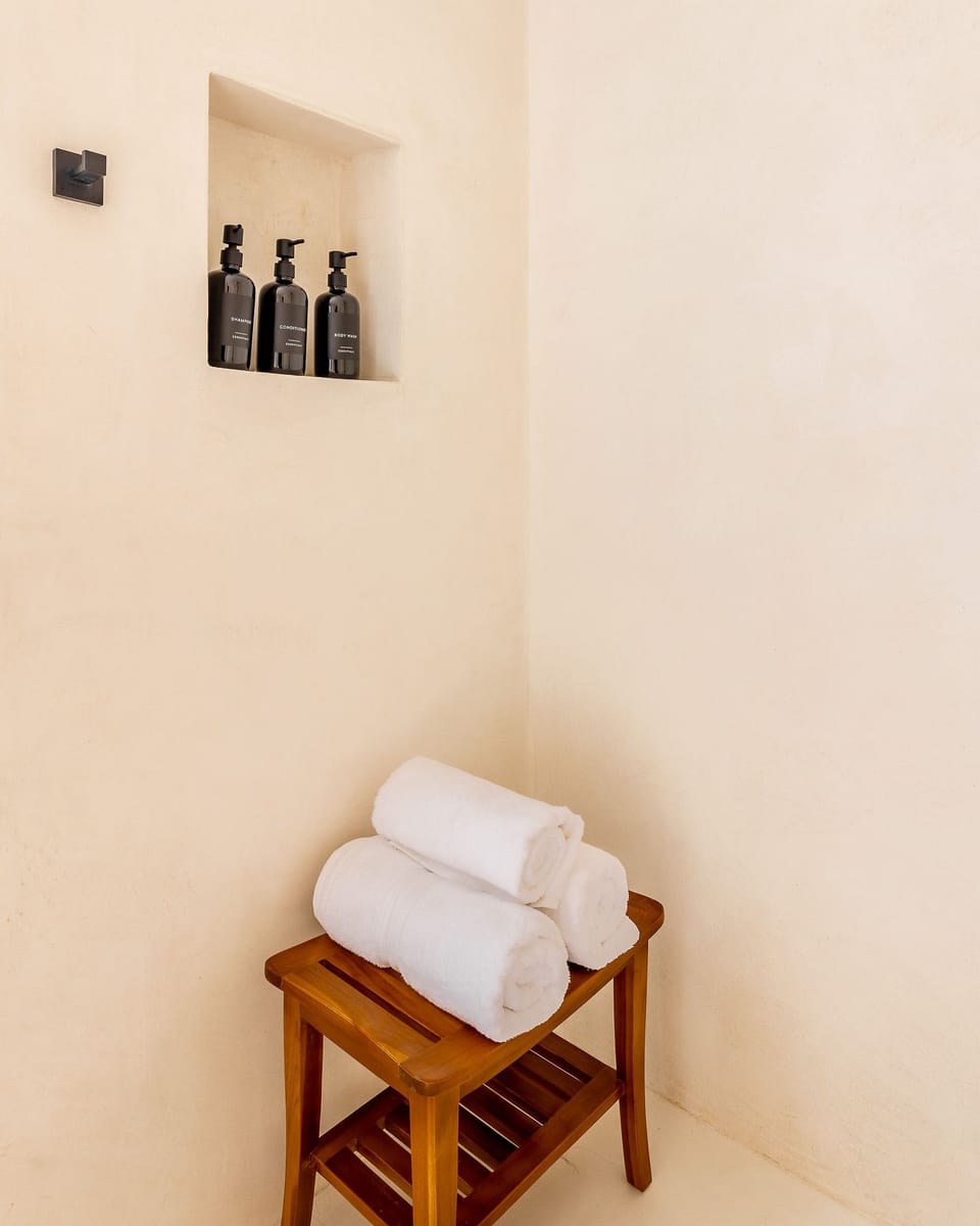 Fresh towels and essential amenities provided for your stay. The studio offers AC, hot water, Smart TV, fast Starlink Wi-Fi, and a prime oceanfront location steps from the sand and beachfront restaurant.