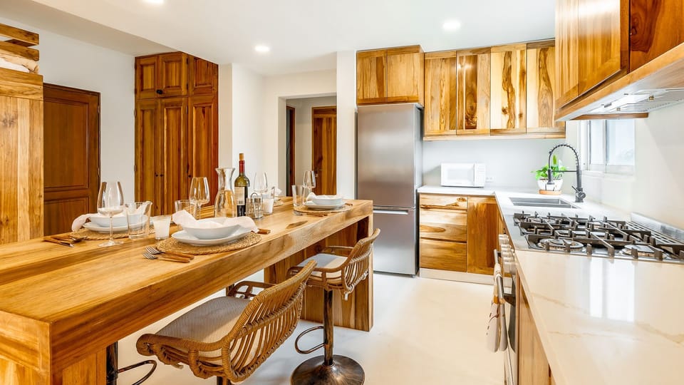 Fully equipped kitchen with oven, microwave, refrigerator, cookware, dishes, and utensils. Perfect for preparing meals, enjoying breakfast, or sharing dinners after a day at the beach.

