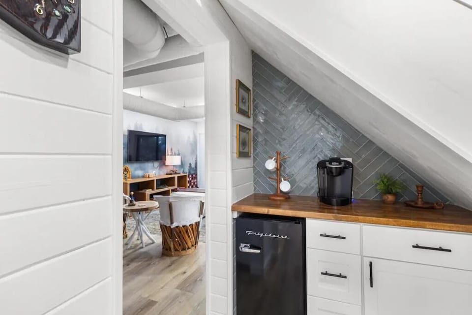 Mini fridge and Keurig located in kitchenette below the stairs.