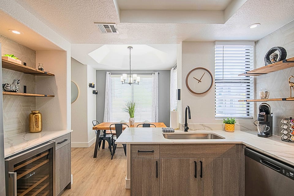 Bright and modern kitchen with an adjacent dining space ideal for enjoying home-cooked meals.