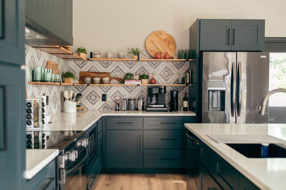 Cook in style in our gourmet kitchen, featuring sleek black cabinetry, high-end appliances, and a spacious island with seating. 