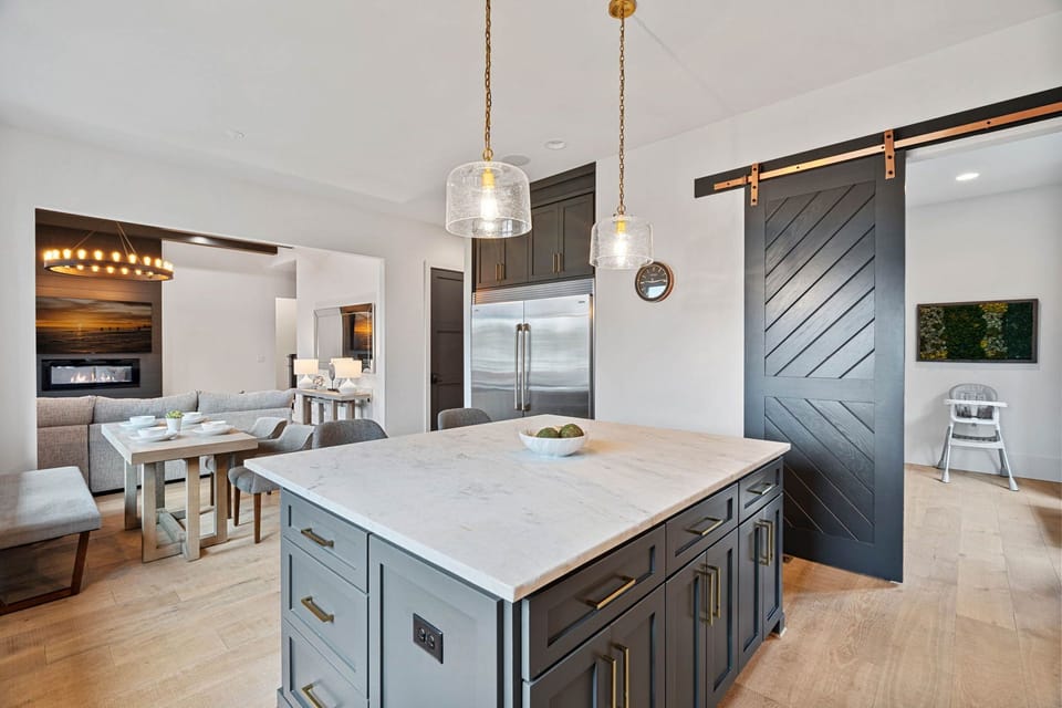 Kitchen island with barn door to pantry/ Scullery.