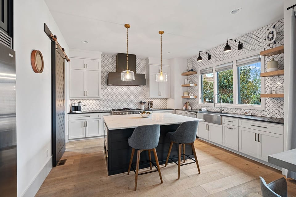 Updated fully stocked kitchen with island seating for 2.