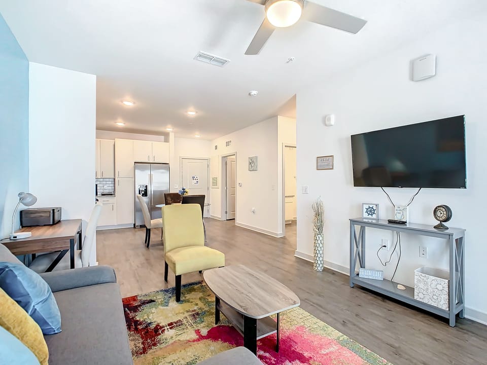 Blend of coziness and technology in our living room, with a sleek 50-inch TV.