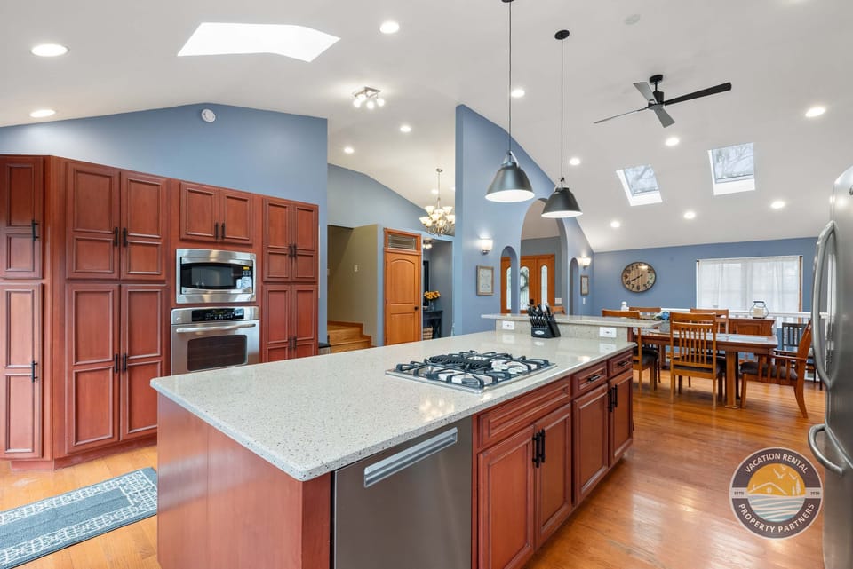 This fully equipped kitchen features a large island, modern appliances, and plenty of counter space for preparing meals, snacks, and shared moments.