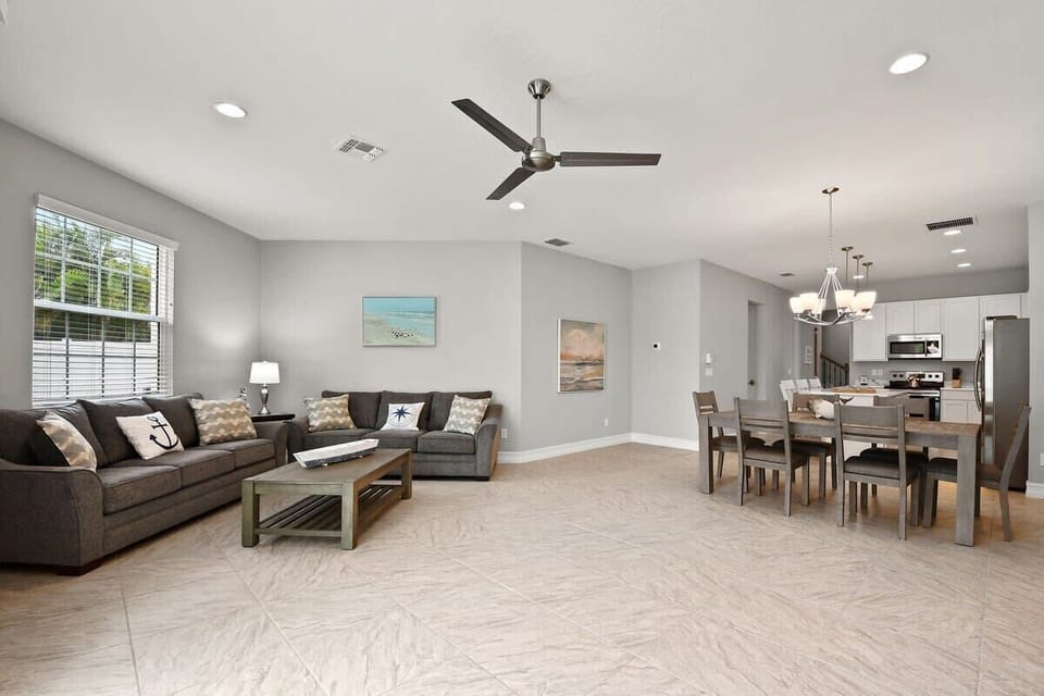 Open-concept living and dining area with modern furnishings and natural light.
