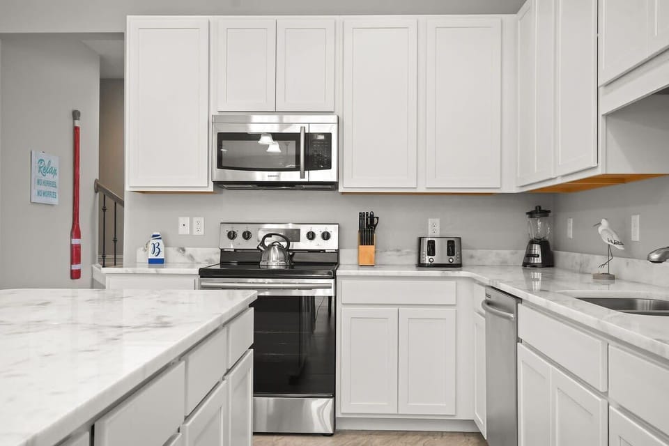 Modern kitchen with stainless steel appliances and marble countertops