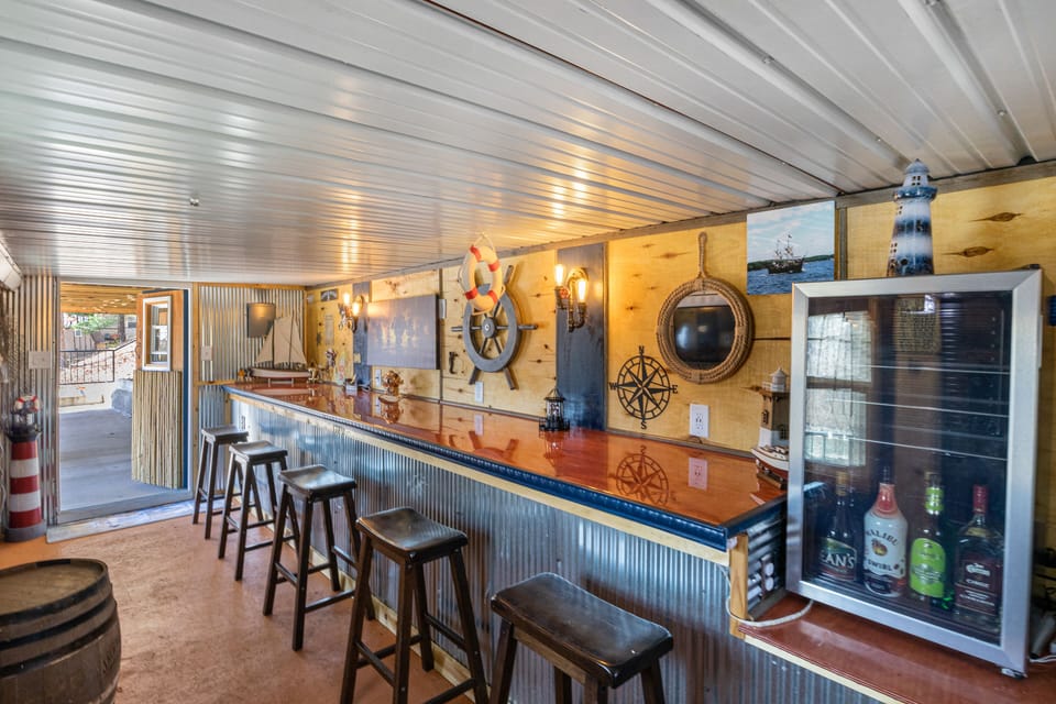 Nautical-themed bar area with rustic decor, perfect for enjoying drinks in a cozy, maritime atmosphere.
