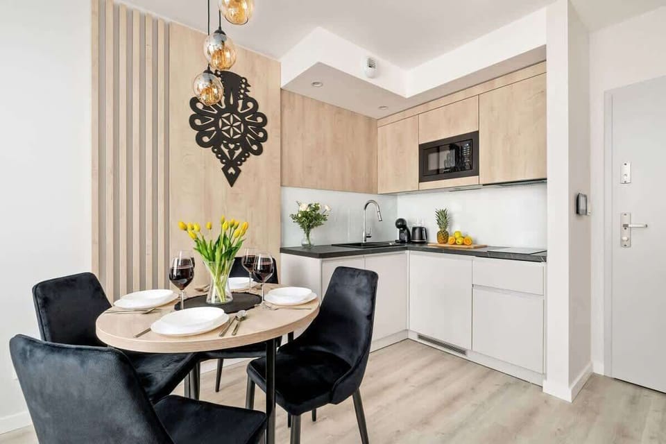 A modern kitchen with light cabinets and black accents is a paradise for cooking enthusiasts.