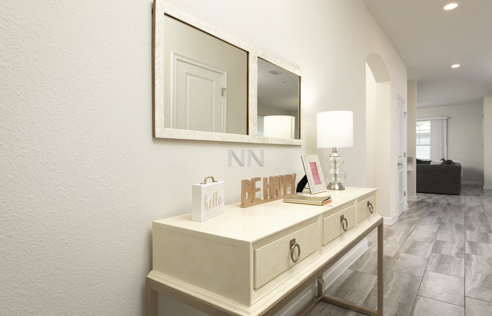 Welcome entry hall adorned with a mirror and a stylish console table.