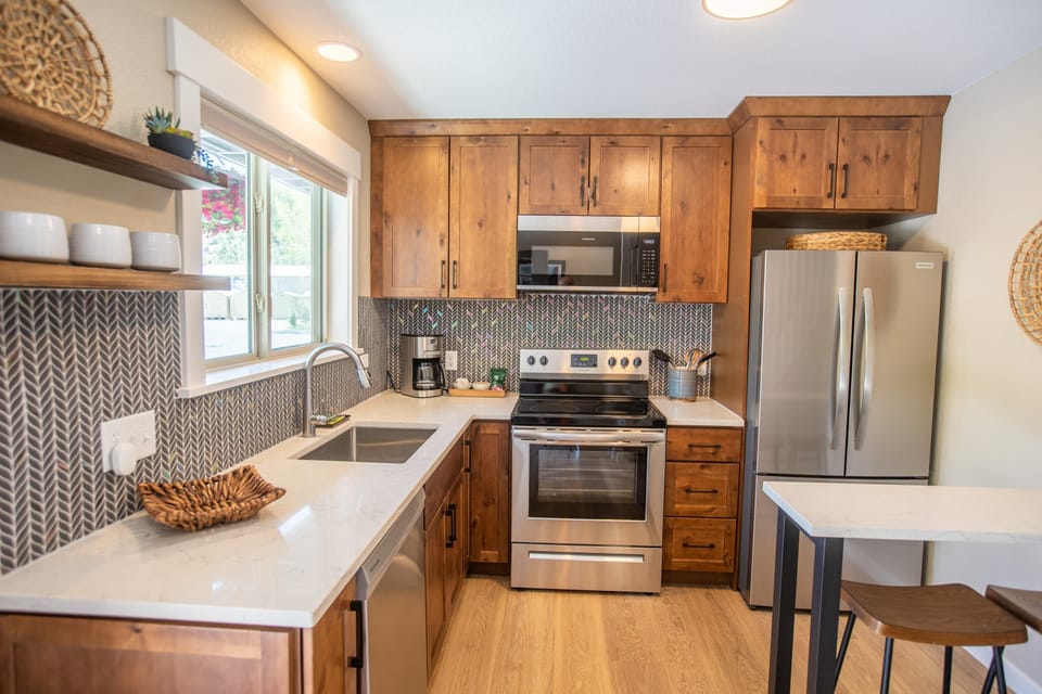 Kitchen with fridge, dishwasher, drip coffee maker, and breakfast bar.jpg