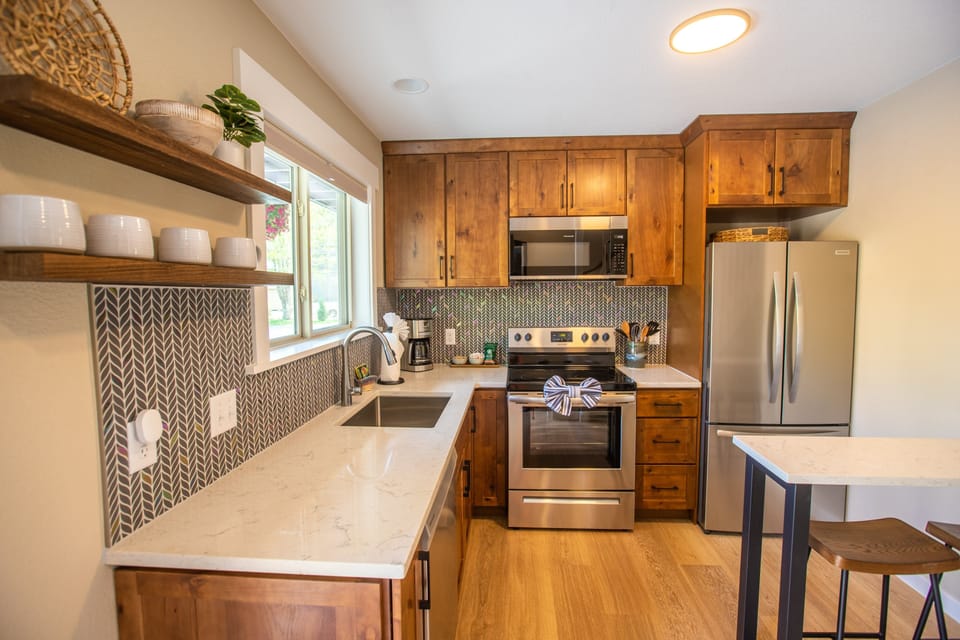 Kitchen with fridge, dishwasher, drip coffee maker, and breakfast bar.jpg