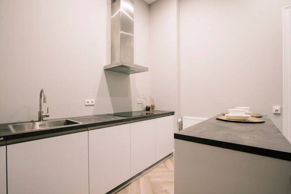 The fully equipped shared kitchen space, featuring modern appliances for a comfortable cooking experience.