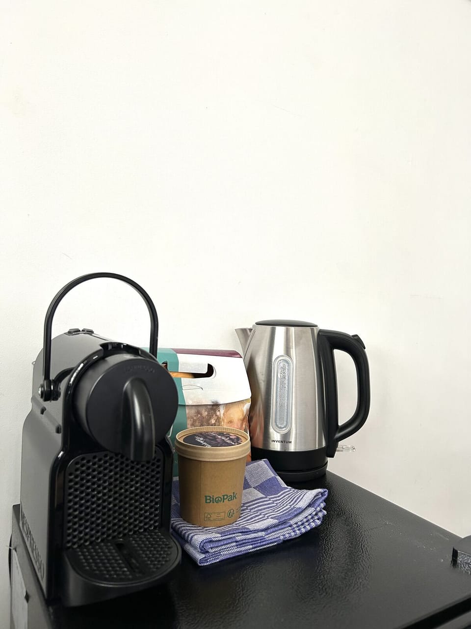 A coffee and tea station featuring a stylish espresso machine and kettle, perfect for a cozy start to your day.