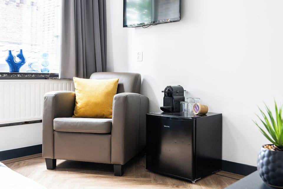 Tiny space, big style—our minimalist bedroom at Bed and Coffee Central is a modern sanctuary, designed for comfort and tranquility during your stay near Hotel Centrum Tilburg.