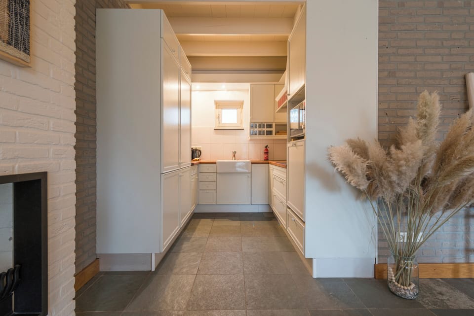A clean and spacious kitchen hallway that leads to an inviting culinary workspace, perfect for preparing family meals.