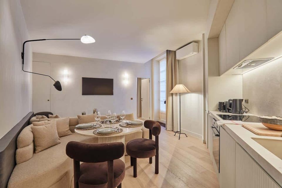 Salon avec canapé, cuisine ouverte et espace repas pour 4 personnes